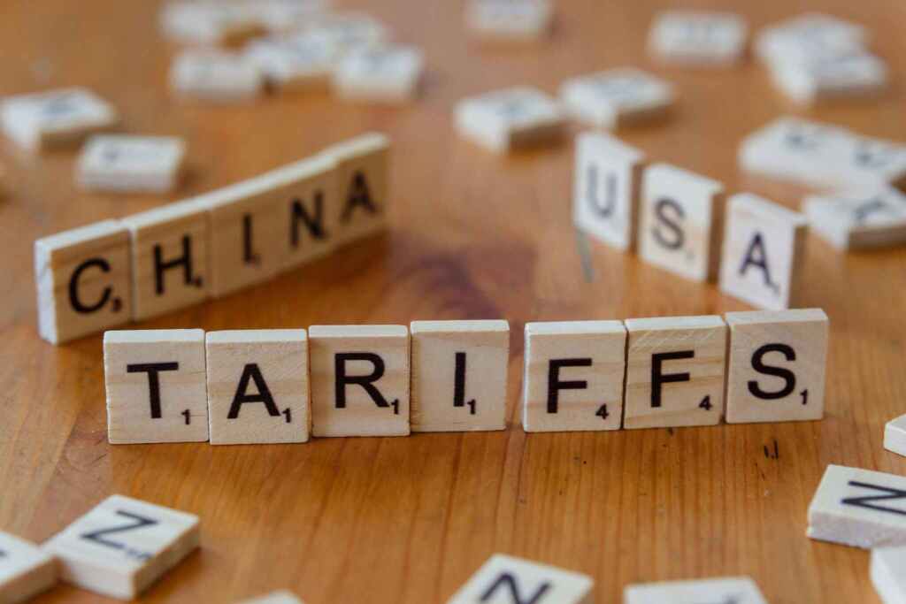 Wooden letter blocks spelling tariffs, China, and USA representing trade relations.